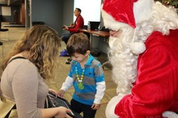 A student uses his tablet to share holiday wishes with Santa.