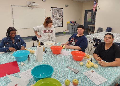 Group of student bakers preparing apples and other ingrediants
