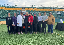 Students and adults pose for group photo outside at event