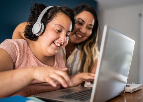 Student with parent at home using laptop