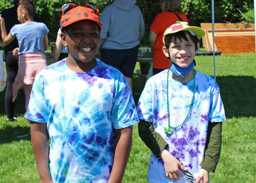 Two students in tie-dye shirts at Fun Fair