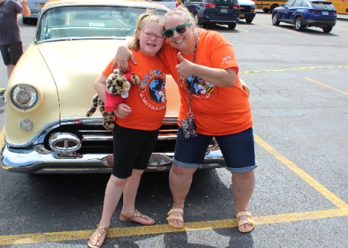 Student and staff member with an antique car