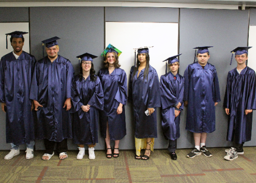 Eight of the thirteen graduates