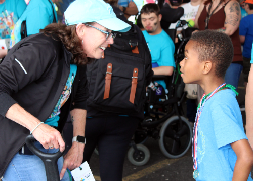 Staff member and student sharing a moment at Fun Fair