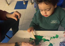Small child painting a tree ornament