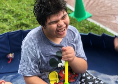 Student having fun with water in a pool