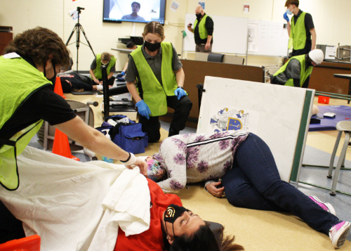 Many students attend to casualties.