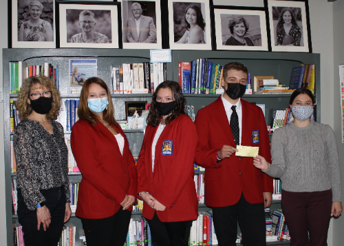 Breast Cancer Coalition staff accept a check from SkillsUSA officers. 