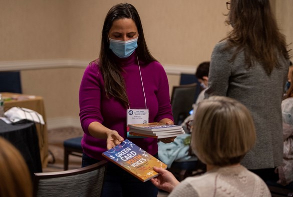 Woman handing over book