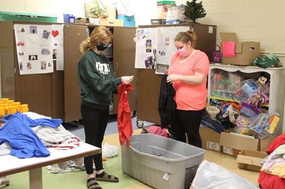 Two CTE students inspecting donations