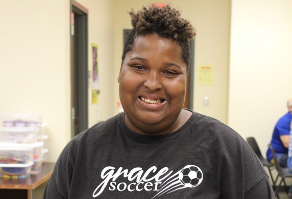 Smiling student wearing soccer t-shirt