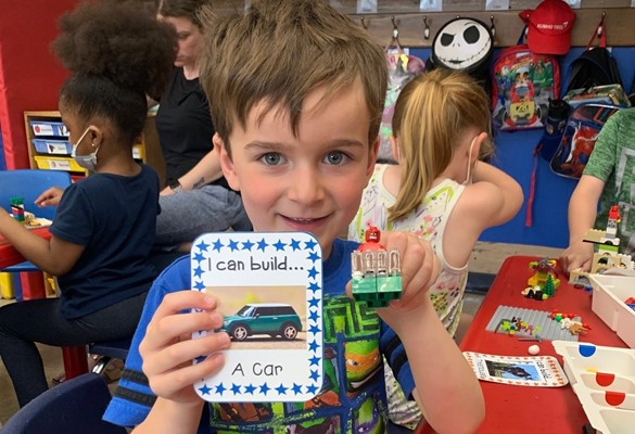 Preschool student building a car