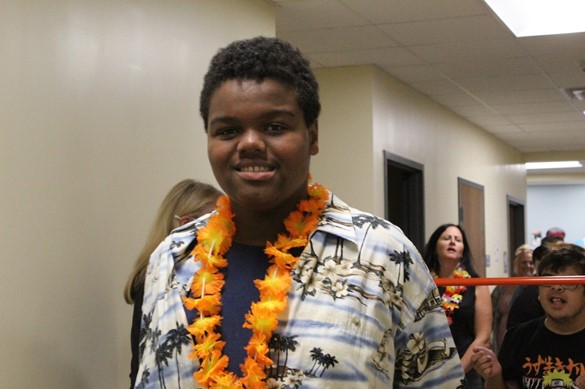 Student wearing tropical shirt and Hawaiian lei