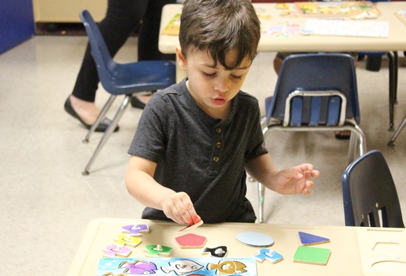Preschool student working on a puzzle