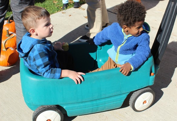 Two students sitting in a cart