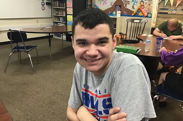 Smiling student with arms crossed