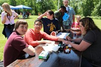 students getting temporary tattoos at fun fair