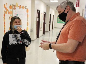 Westside Academy teacher with student in hallway