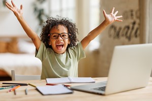 Student with arms raised in happiness