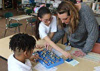 Teacher working with several students