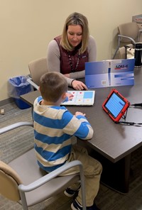 School psychologist assessing student