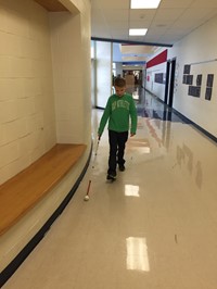 Student walking down a hallway