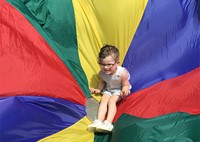 Student on rainbow-colored parachute