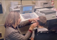 Audiologist working with student